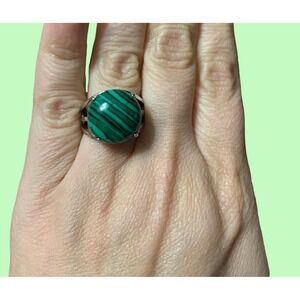Stunning green malachite like stone set in a sleek silver‎ band.